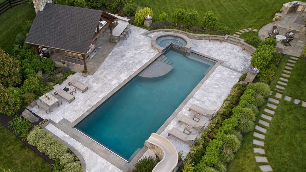 Pac-Man style three quarter spa with the fourth quarter turned into a tanning ledge